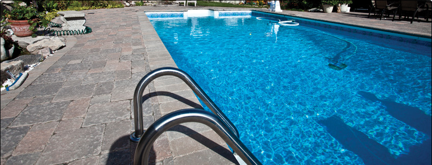 rectangular pool and stone patio